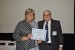 Dr. Nagib Callaos, General Chair, giving Dr. Lorayne Robertson the best paper award certificate of the session "Education in Science, Technology, Engineering and its Applications." The title of the awarded paper is "BYOD as One Interdisciplinary Response to Address Gaps between In-School and Out-of-School Learning in the 21st Century."